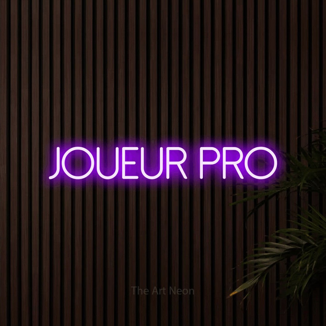 “Joueur pro” LED neon sign in purple, with thin sans-serif lettering, shown against dark wooden wall slats.