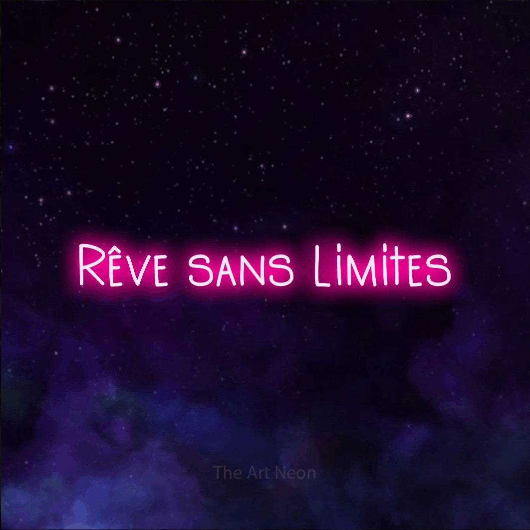 “Rêve sans limites” LED neon sign in hot pink, with narrow hand-drawn lettering, shown against a purple galaxy backdrop.