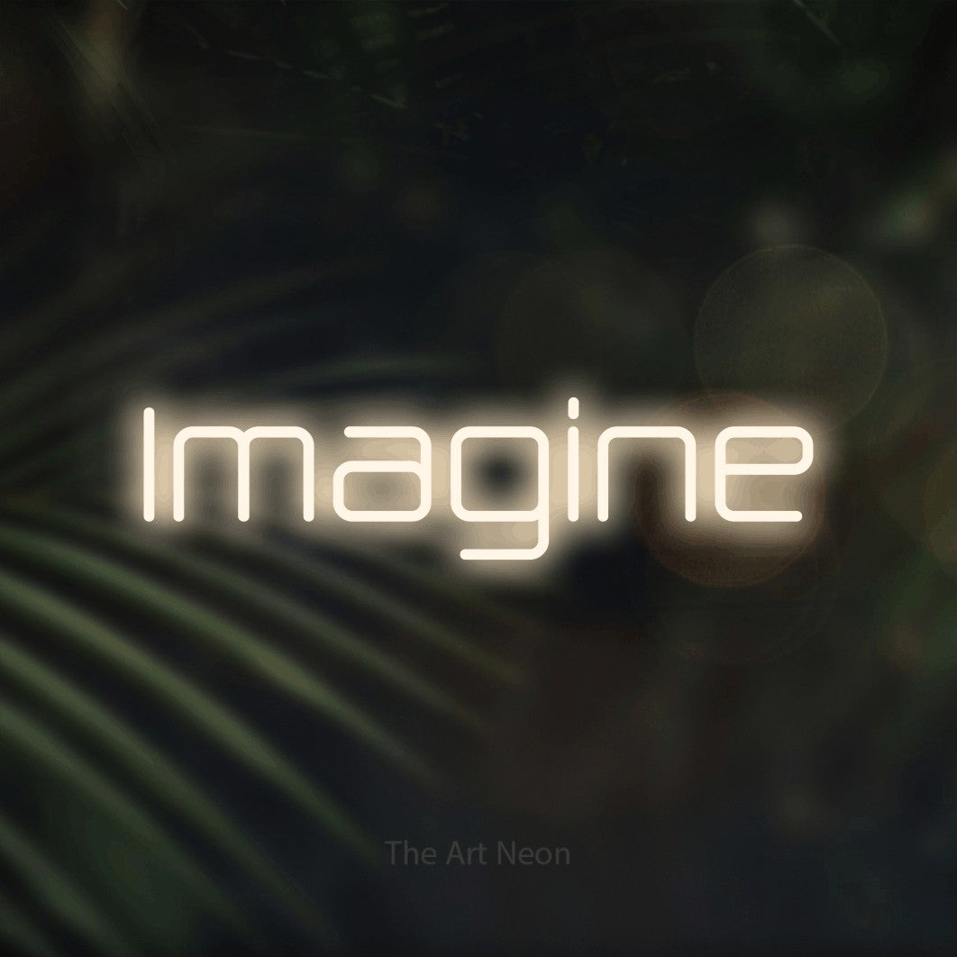 “Imagine” LED neon sign in warm white, with rounded geometric lettering, shown against a blurred palm and bokeh-light backdrop.