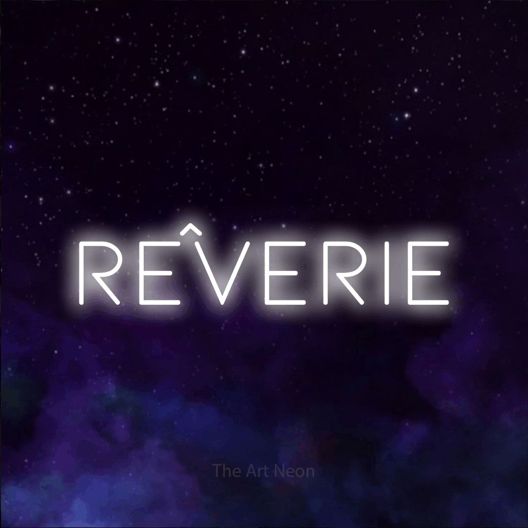 “Rêverie” LED neon sign in cool white, with thin, widely spaced lettering, shown against a purple galaxy backdrop.