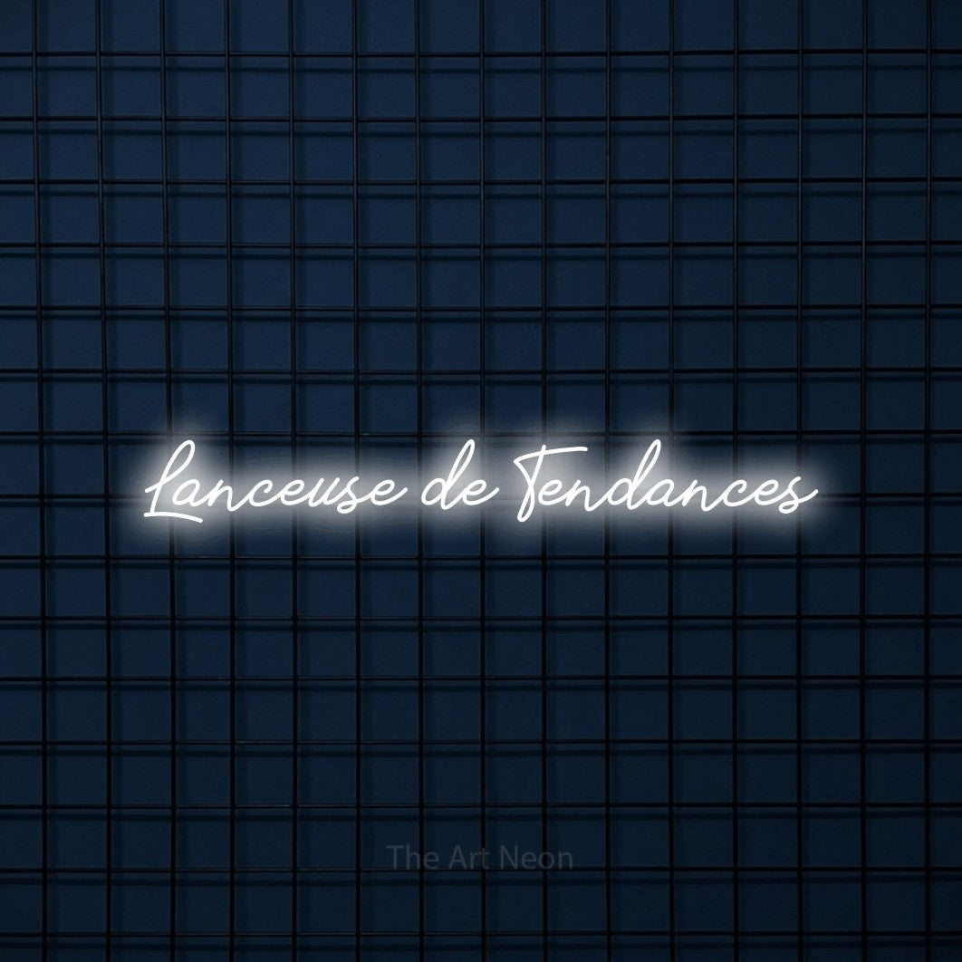 “Lanceuse de tendances” LED neon sign in cool white, with cursive lettering, shown against a dark blue grid.