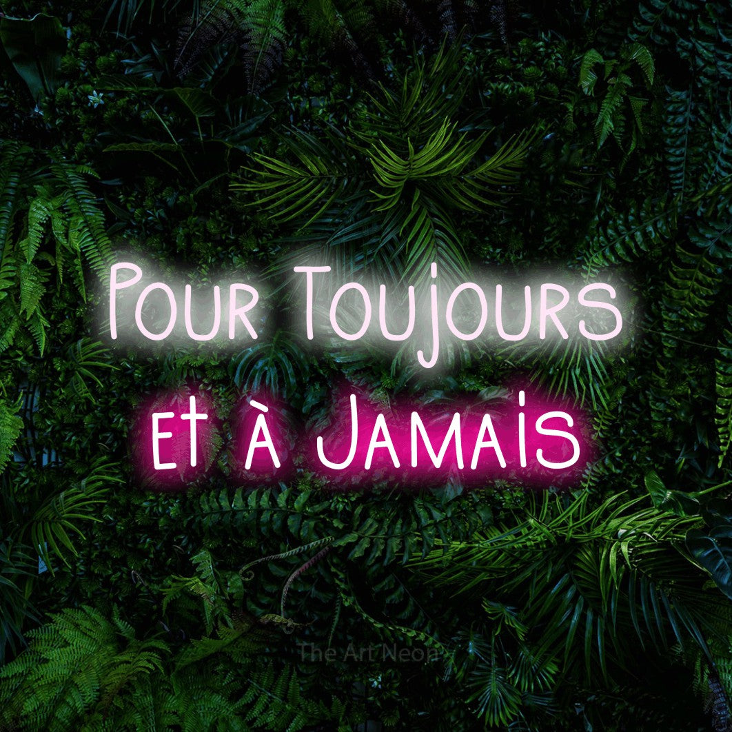 “Pour toujours et à jamais” LED neon sign in cool white on the upper line and hot pink on the lower line, with narrow hand-drawn lettering across 2 lines, shown against dense tropical foliage.