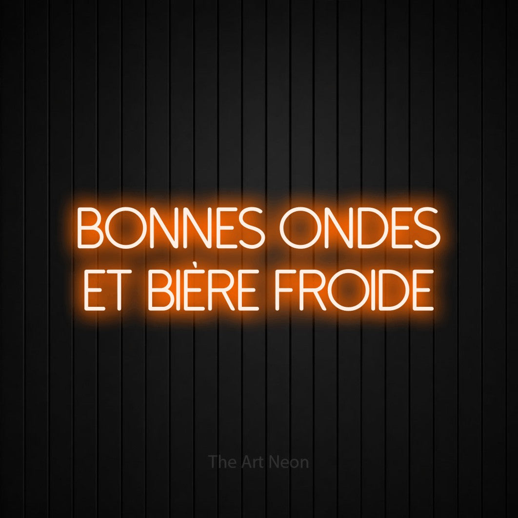 “Bonnes ondes et bière froide” LED neon sign in orange, with thin sans-serif lettering across 2 lines, shown against black vertical wall slats.