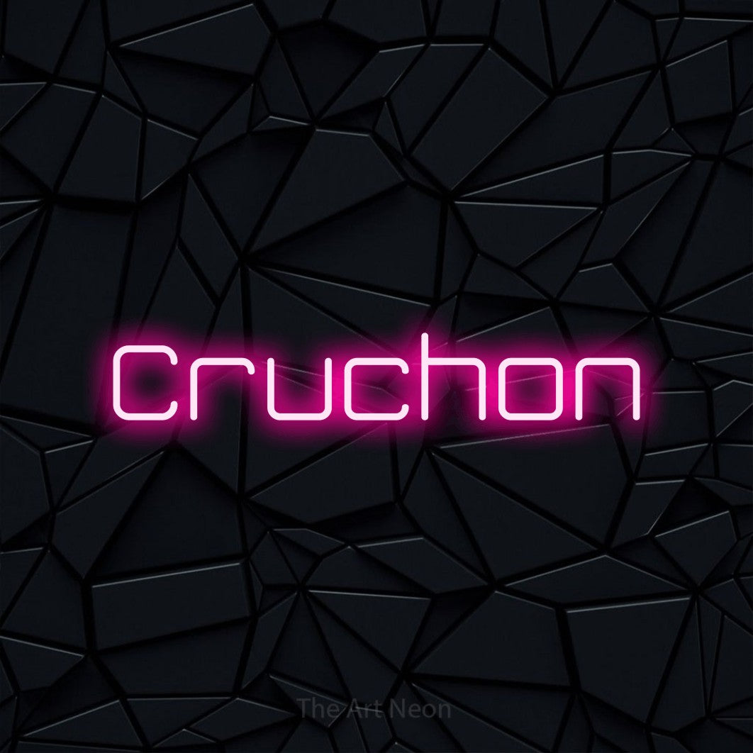 “Cruchon” LED neon sign in hot pink, with rounded geometric lettering, shown against a black polygonal surface.