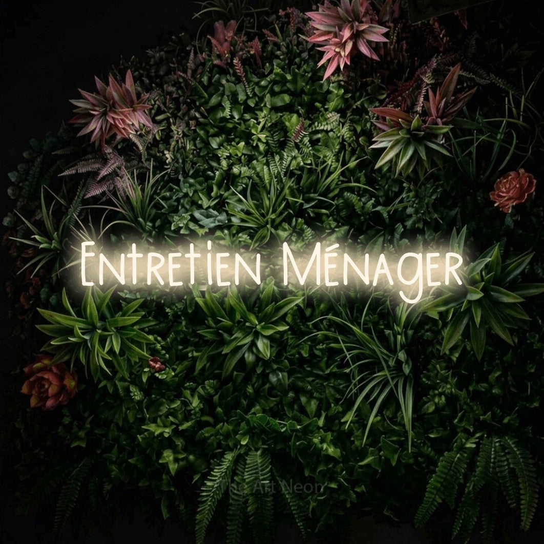 “Entretien ménager” LED neon sign in warm white, with narrow hand-drawn lettering, shown against a flowering plant wall.