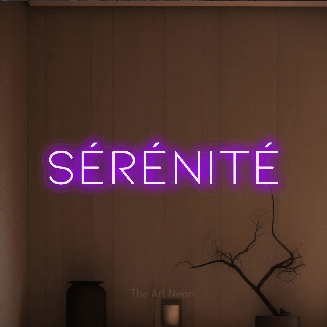 “Sérénité” LED neon sign in purple, with thin, widely spaced lettering, shown against a simple earth-toned interior.