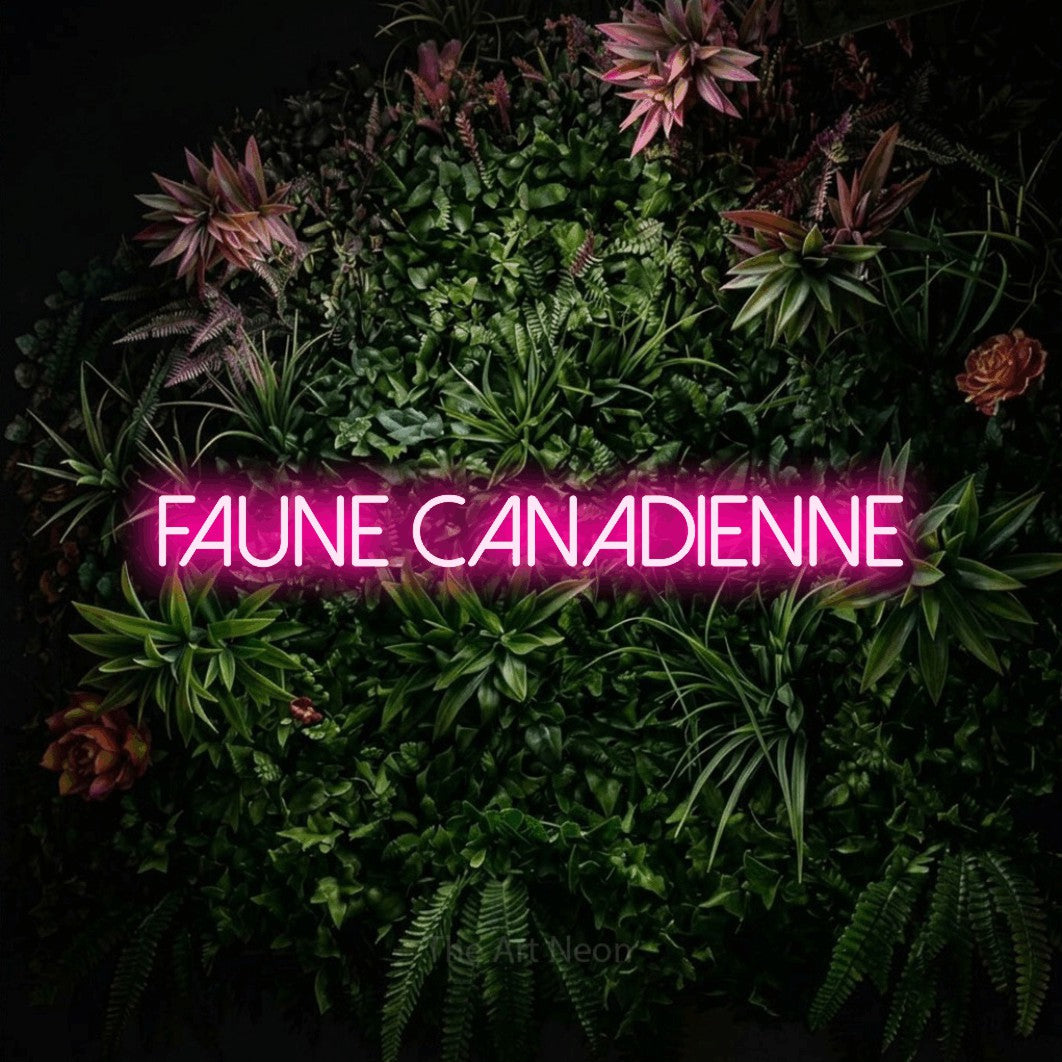 “Faune canadienne” LED neon sign in hot pink, with thin sans-serif lettering, shown against a flowering plant wall.
