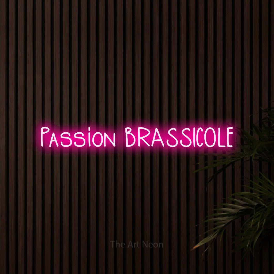 “Passion brassicole” LED neon sign in hot pink, with narrow hand-drawn lettering, shown against dark wooden wall slats.