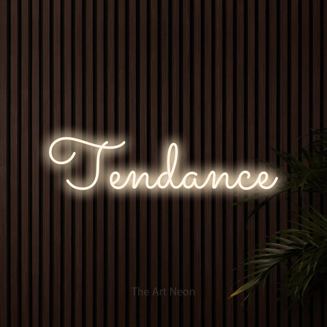 “Tendance” LED neon sign in warm white, with looped cursive lettering, shown against dark wooden wall slats.
