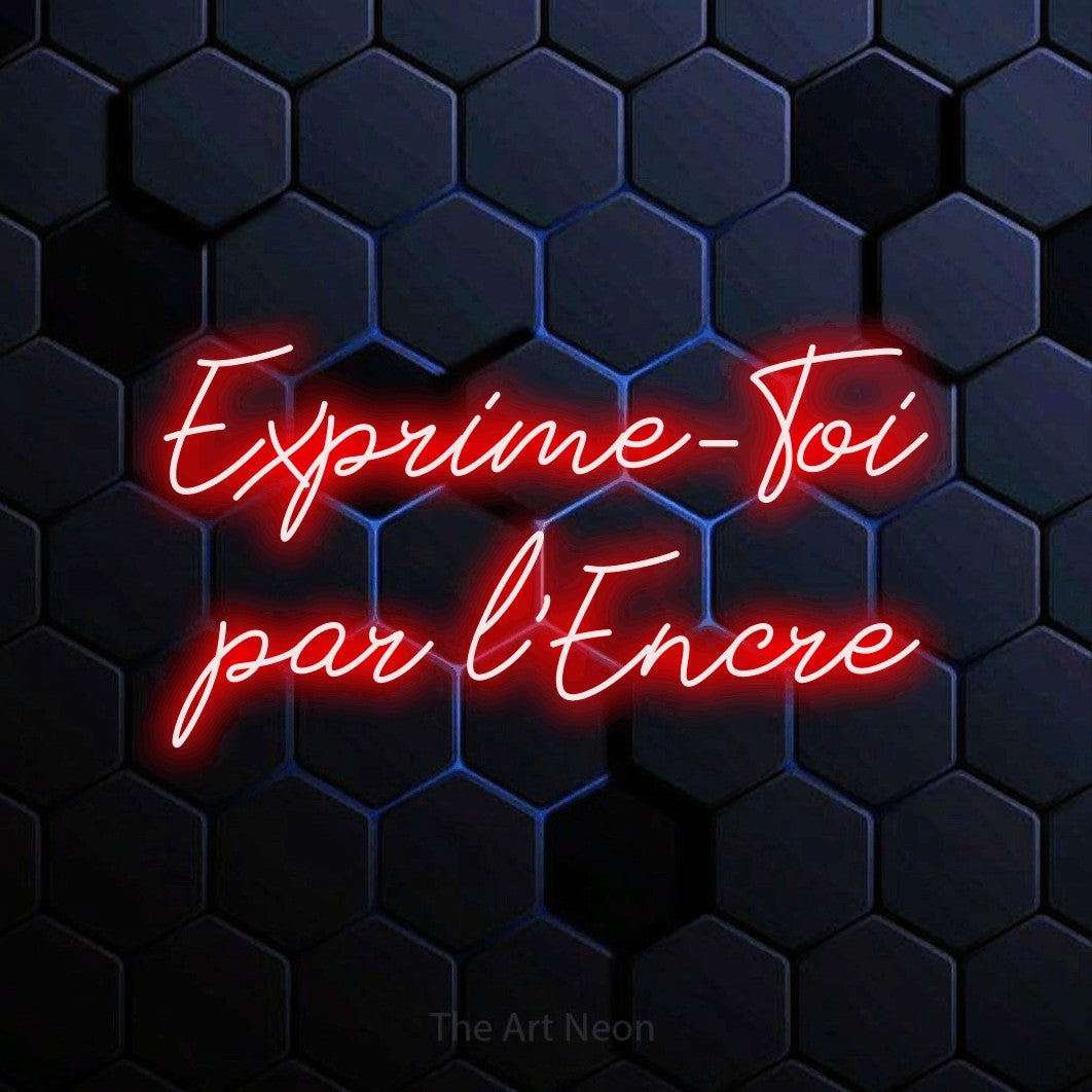 “Exprime-toi par l'encre” LED neon sign in red, with cursive lettering across 2 lines, shown against a dark blue honeycomb pattern.