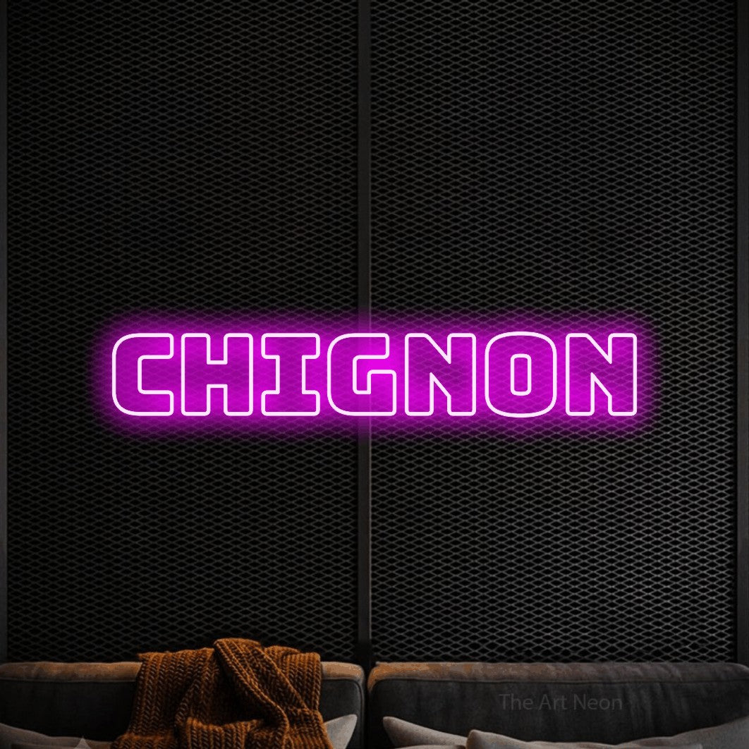 “Chignon” LED neon sign in pink, with bold outline lettering, shown against a modern dark-toned seating area.