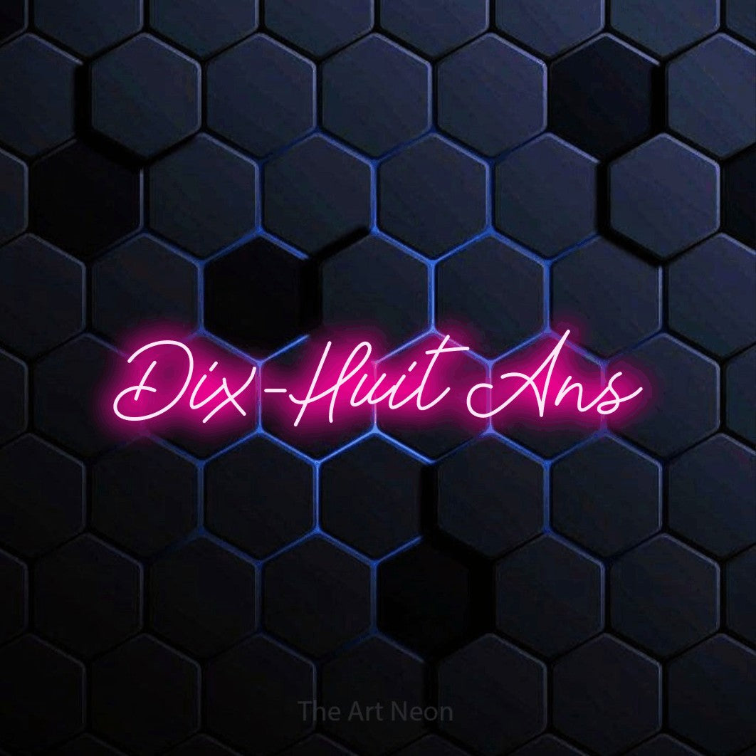“Dix-huit ans” LED neon sign in hot pink, with cursive lettering, shown against a dark blue honeycomb pattern.