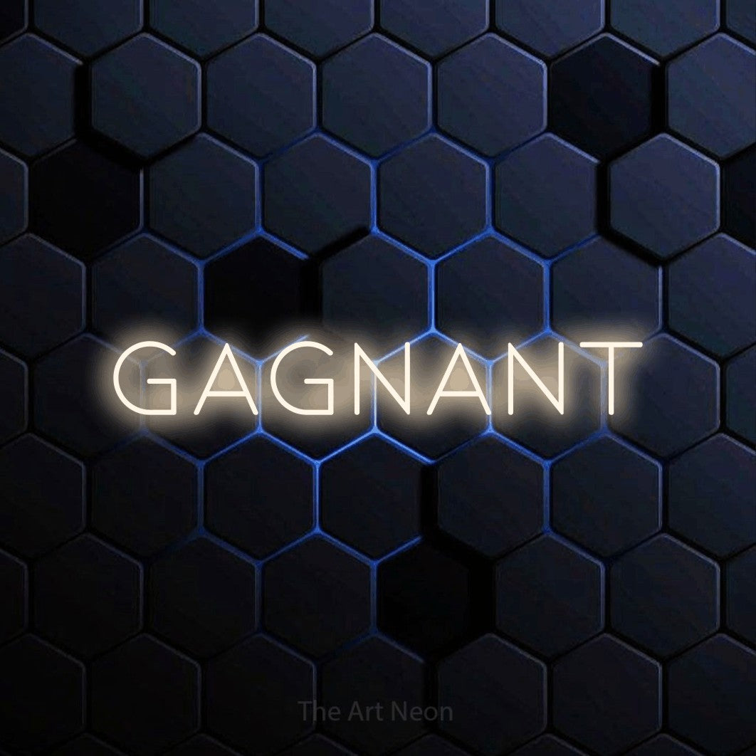 “Gagnant” LED neon sign in warm white, with thin, widely spaced lettering, shown against a dark blue honeycomb pattern.
