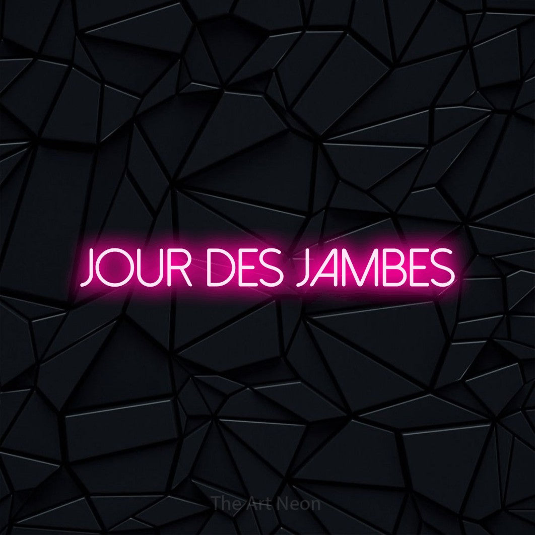 “Jour des jambes” LED neon sign in hot pink, with thin sans-serif lettering, shown against a black polygonal surface.