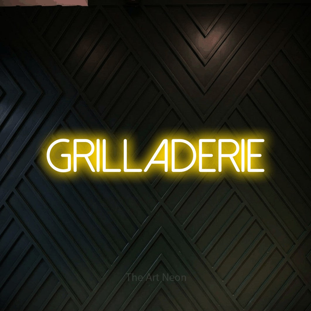 “Grilladerie” LED neon sign in yellow, with thin sans-serif lettering, shown against a black chevron-patterned wood wall.