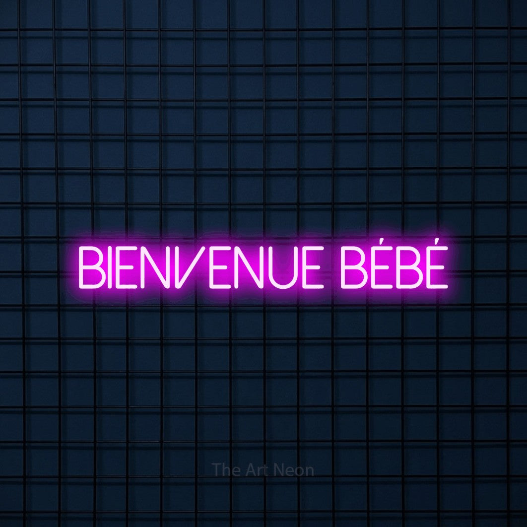 “Bienvenue bébé” LED neon sign in pink, with thin sans-serif lettering, shown against a dark blue grid.