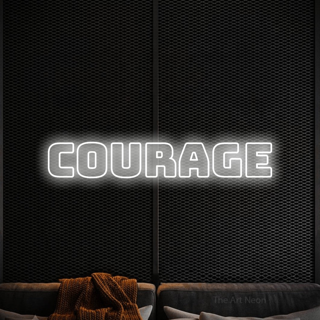 “Courage” LED neon sign in cool white, with bold outline lettering, shown against a modern dark-toned seating area.