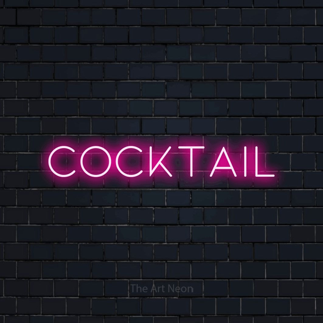 Aperçu d’une enseigne néon LED « Cocktail » en rose vif, en lettres fines et espacées, photographiée sur un mur de briques bleu marine foncé, pour une cuisine.