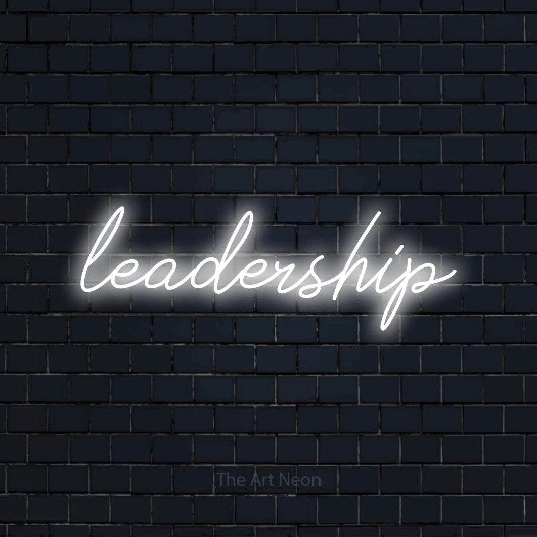 “Leadership” LED neon sign in cool white, with cursive lettering, shown against a dark navy brick wall.
