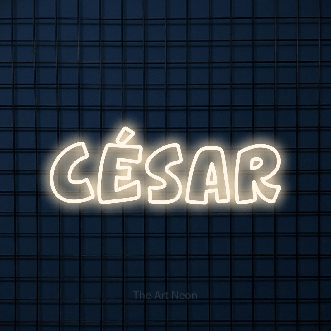 “César” LED neon sign in warm white, with rounded outline lettering, shown against a dark blue grid.