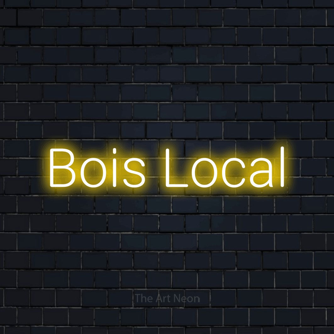 Enseigne néon LED « Bois local » en jaune, en lettres sans empattement arrondies, présentée sur un mur de briques bleu marine foncé, pour un bar ou un pub.