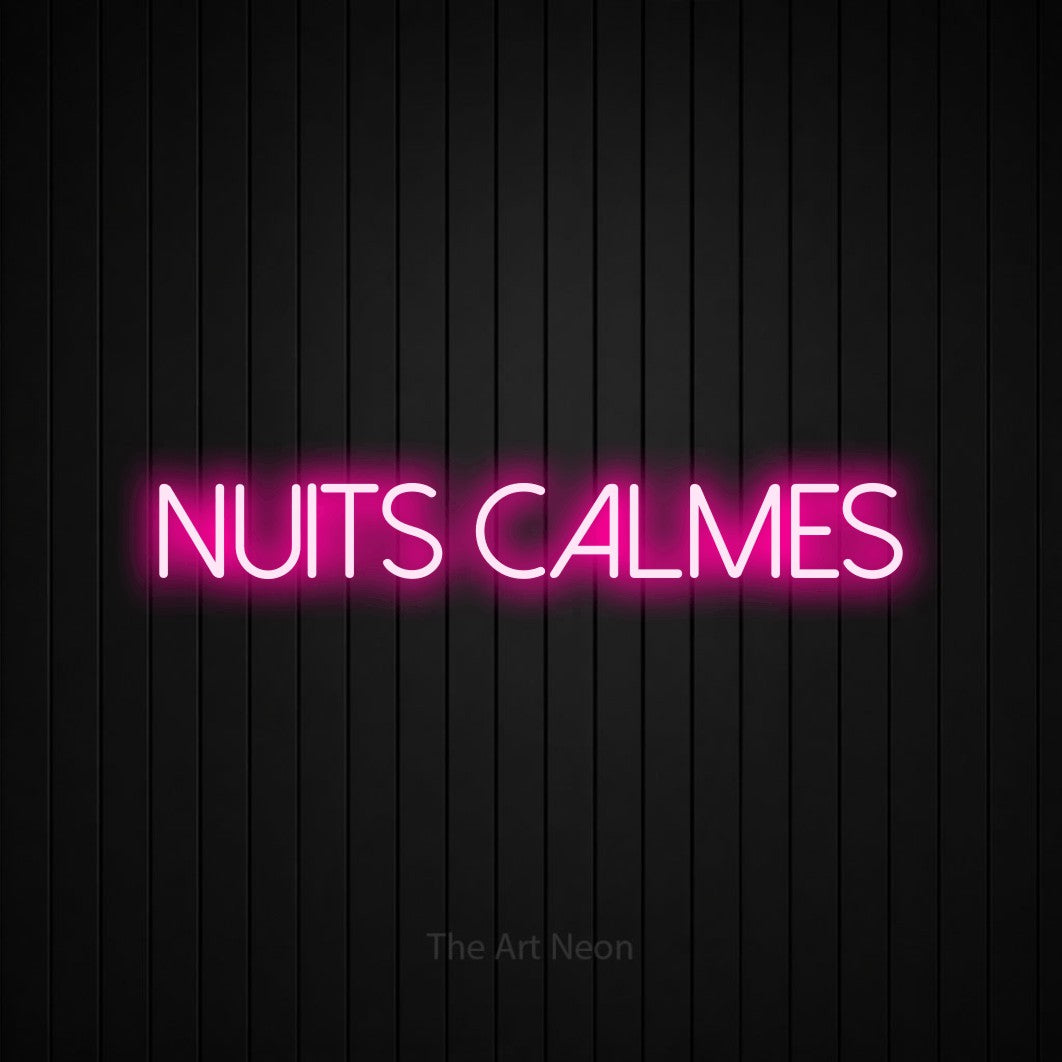 “Nuits calmes” LED neon sign in hot pink, with thin sans-serif lettering, shown against black vertical wall slats.