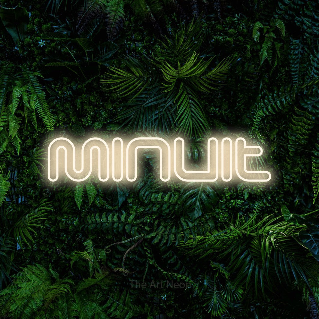 “Minuit” LED neon sign in warm white, with futuristic double-line lettering, shown against dense tropical foliage.