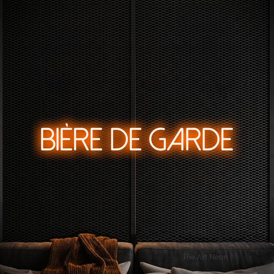 “Bière de garde” LED neon sign in orange, with thin sans-serif lettering, shown against a modern dark-toned seating area.