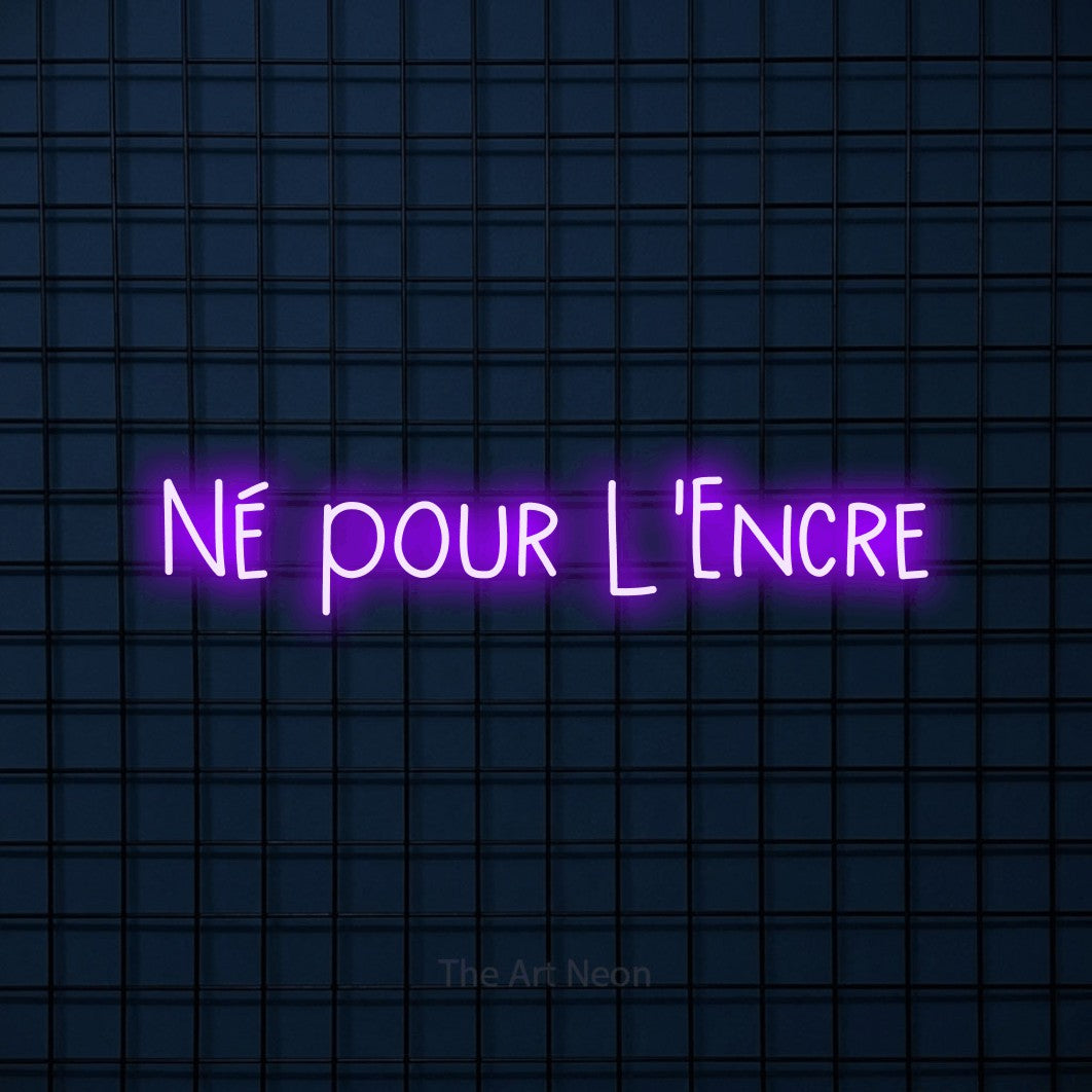 “Né pour l'encre” LED neon sign in purple, with narrow hand-drawn lettering, shown against a dark blue grid.