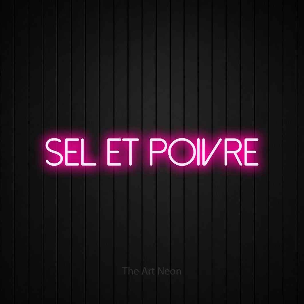 “Sel et poivre” LED neon sign in hot pink, with thin sans-serif lettering, shown against black vertical wall slats.