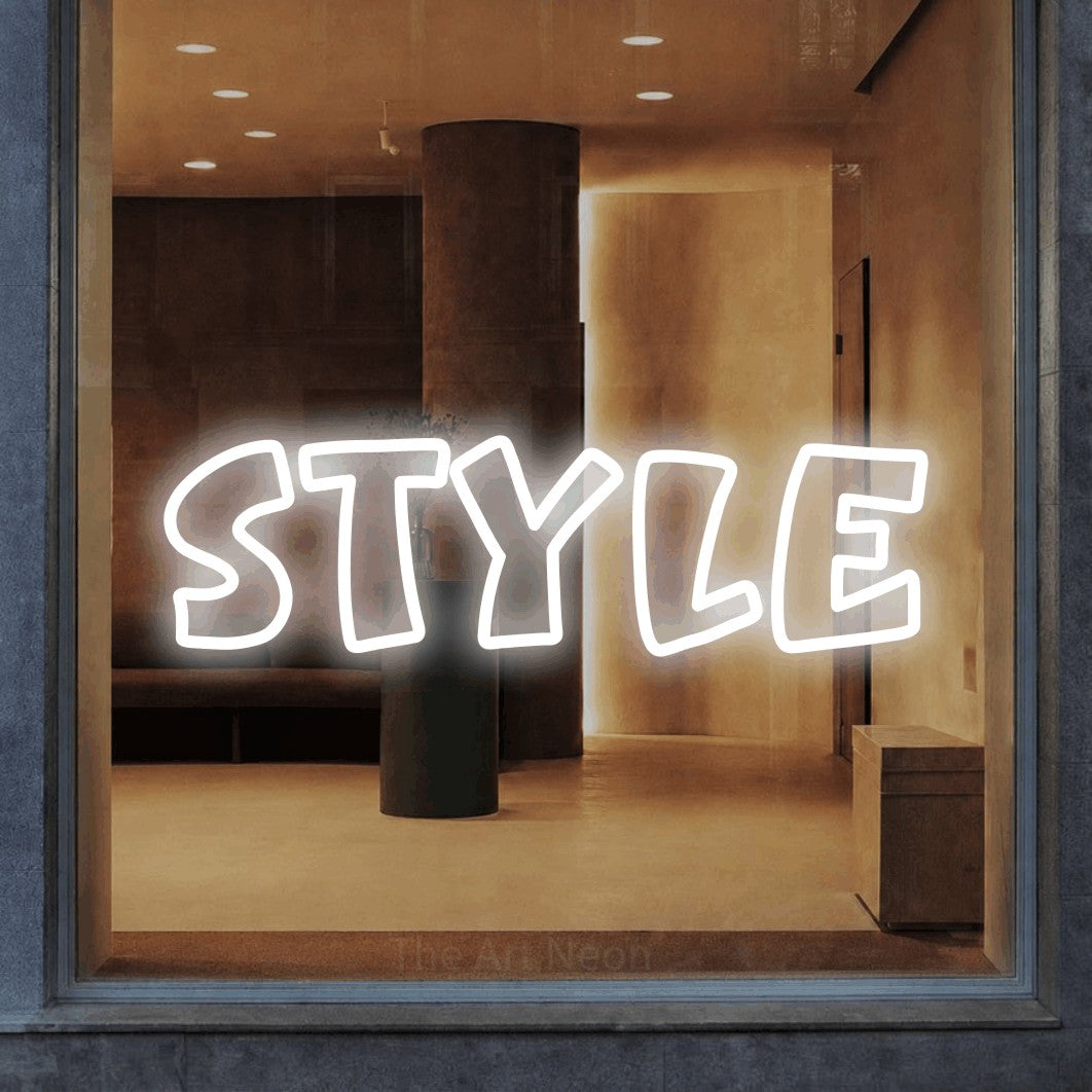 “Style” LED neon sign in cool white, with rounded outline lettering, shown against a warm-toned interior.