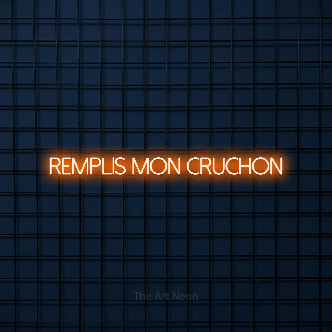 “Remplis mon cruchon” LED neon sign in orange, with thin sans-serif lettering, shown against a dark blue grid.