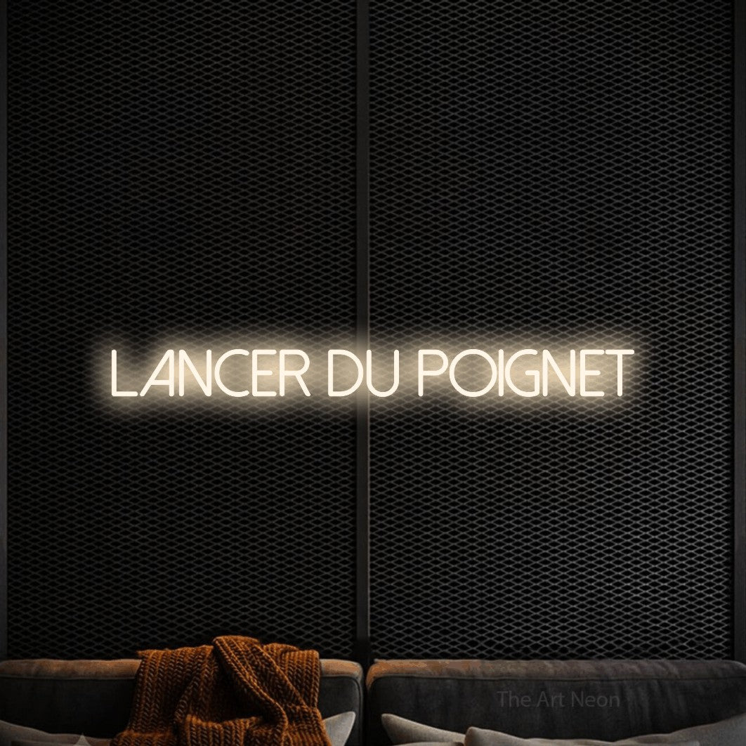 “Lancer du poignet” LED neon sign in warm white, with thin sans-serif lettering, shown against a modern dark-toned seating area.