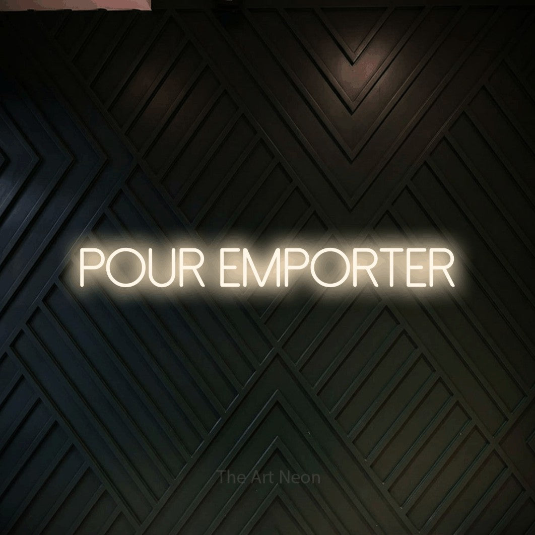 “Pour emporter” LED neon sign in warm white, with thin sans-serif lettering, shown against a black chevron-patterned wood wall.