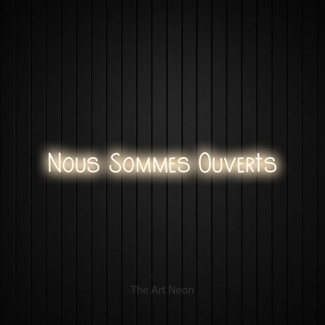 “Nous sommes ouverts” LED neon sign in warm white, with narrow hand-drawn lettering, shown against black vertical wall slats.