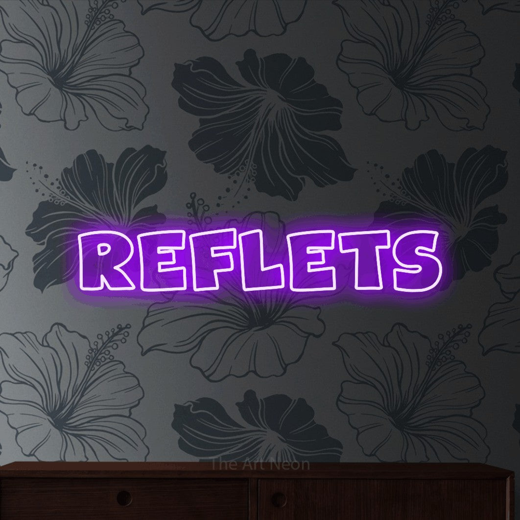 “Reflets” LED neon sign in purple, with wide lettering with irregular outlines, shown against a grey floral-patterned wall.