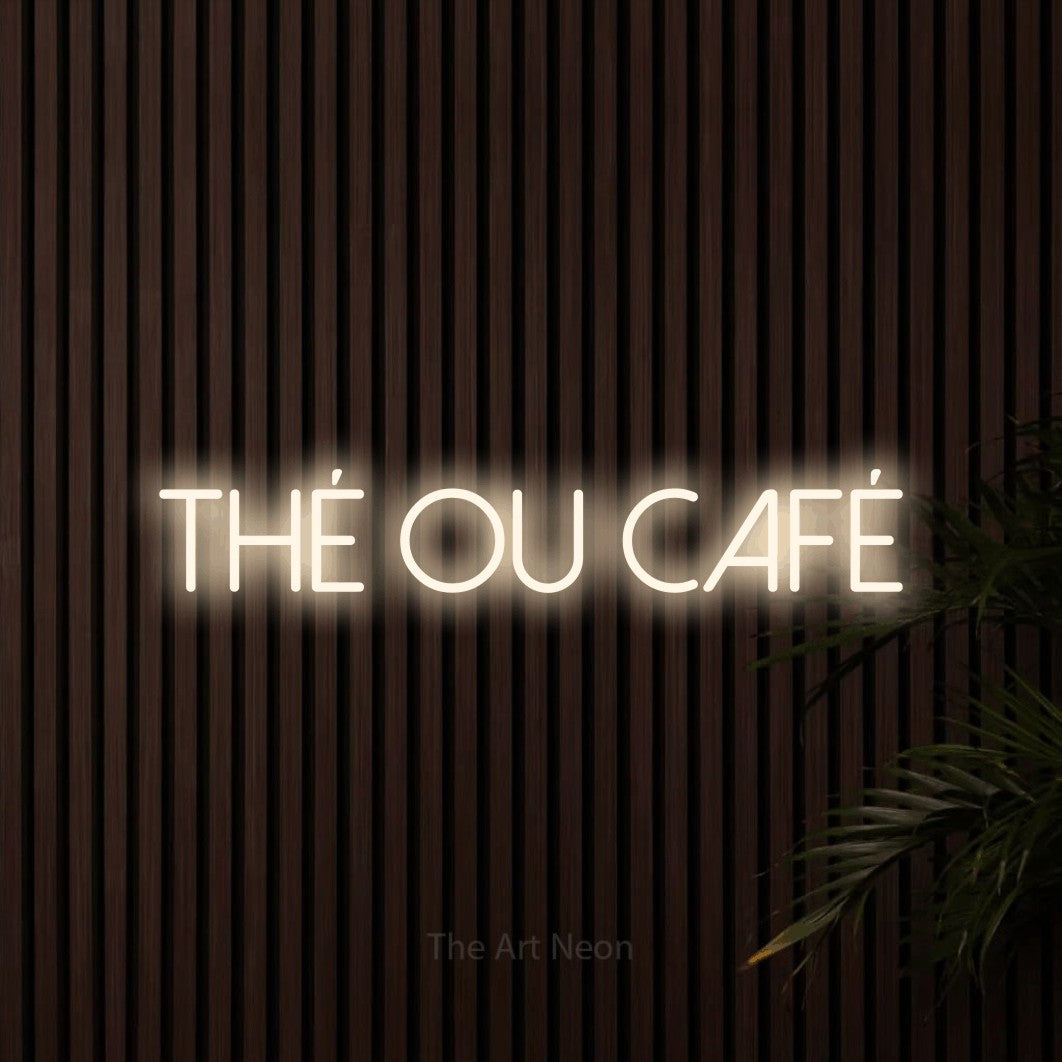 “Thé ou café” LED neon sign in warm white, with thin sans-serif lettering, shown against dark wooden wall slats.