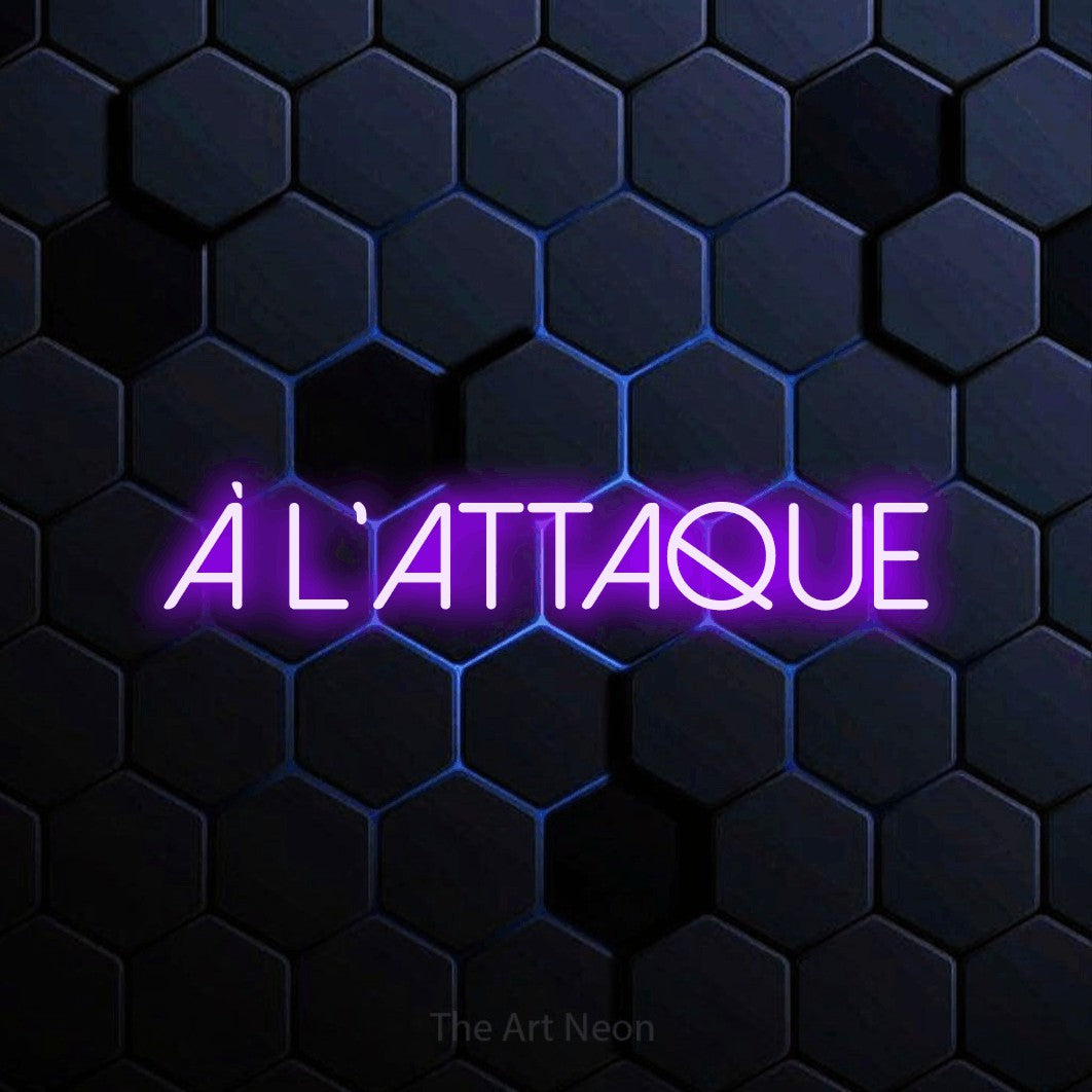 “À l'attaque” LED neon sign in purple, with thin sans-serif lettering, shown against a dark blue honeycomb pattern.