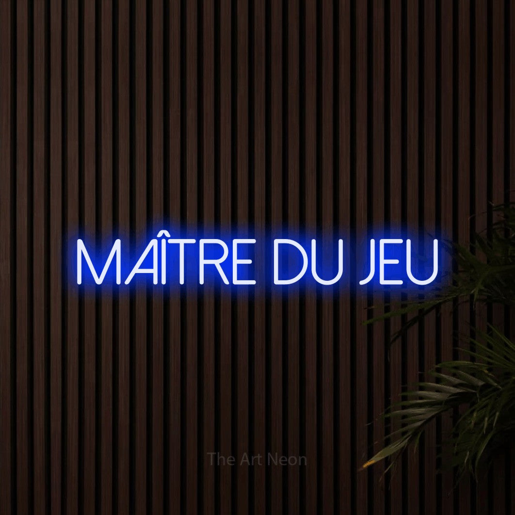 “Maître du jeu” LED neon sign in blue, with thin sans-serif lettering, shown against dark wooden wall slats.