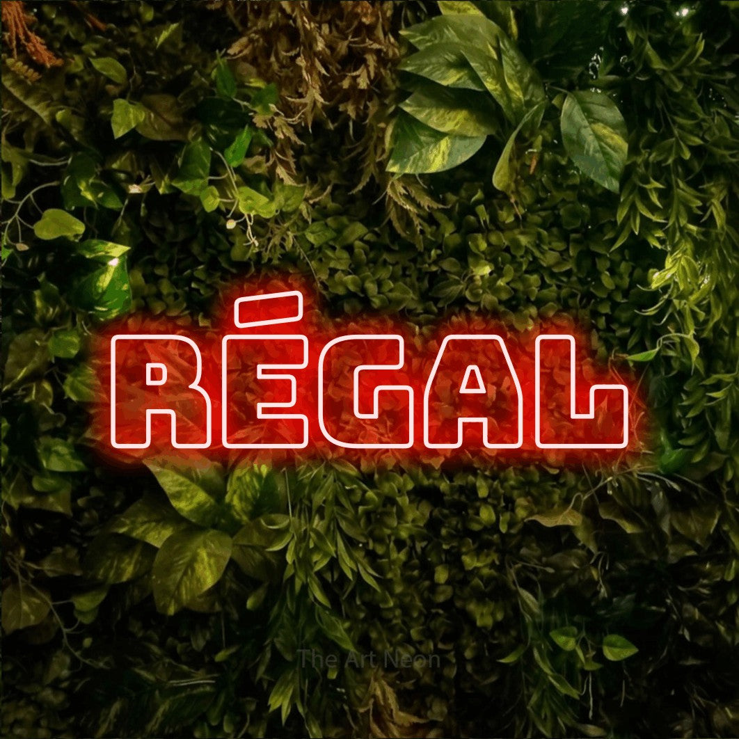 “Régal” LED neon sign in red, with bold outline lettering, shown against bright green and yellow foliage.