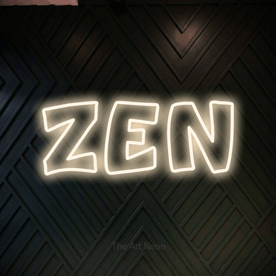 “Zen” LED neon sign in warm white, with rounded outline lettering, shown against a black chevron-patterned wood wall.