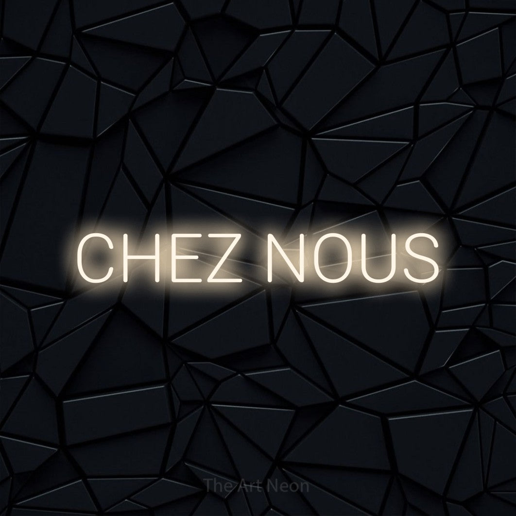 “Chez nous” LED neon sign in warm white, with rounded sans-serif lettering, shown against a black polygonal surface.