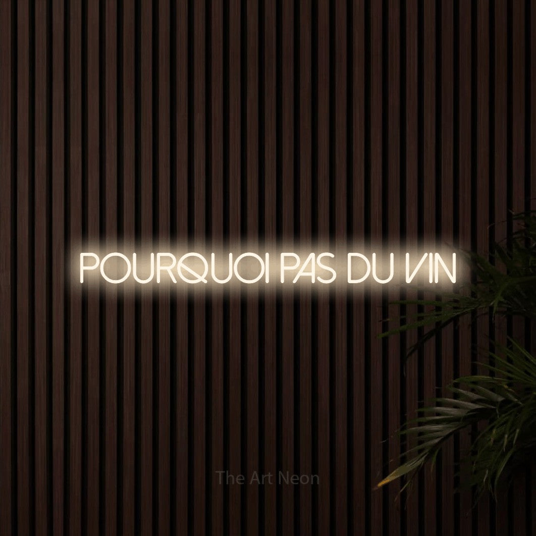 “Pourquoi pas du vin” LED neon sign in warm white, with thin sans-serif lettering, shown against dark wooden wall slats.