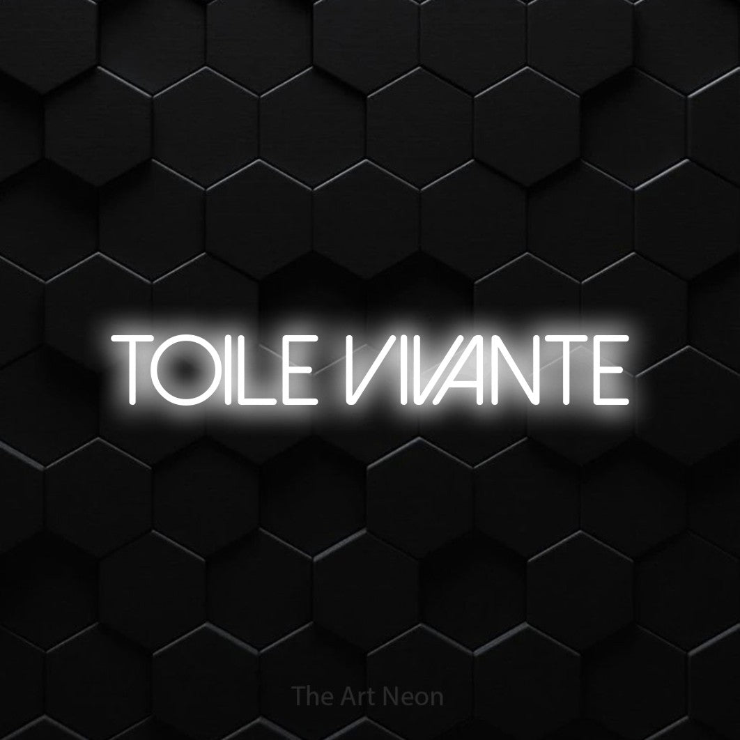 “Toile vivante” LED neon sign in cool white, with thin sans-serif lettering, shown against black hexagonal wall tiles.