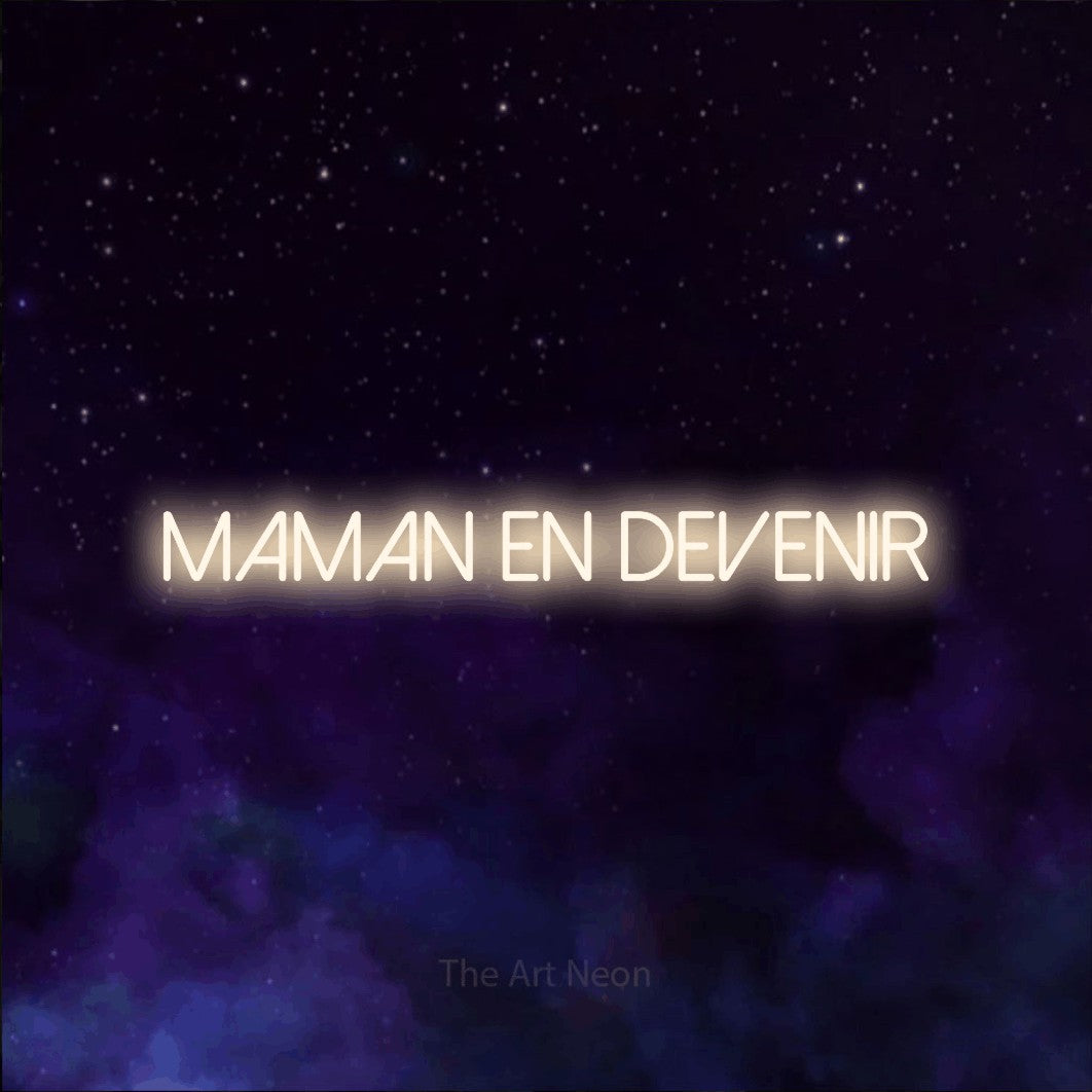 “Maman en devenir” LED neon sign in warm white, with thin sans-serif lettering, shown against a purple galaxy backdrop.