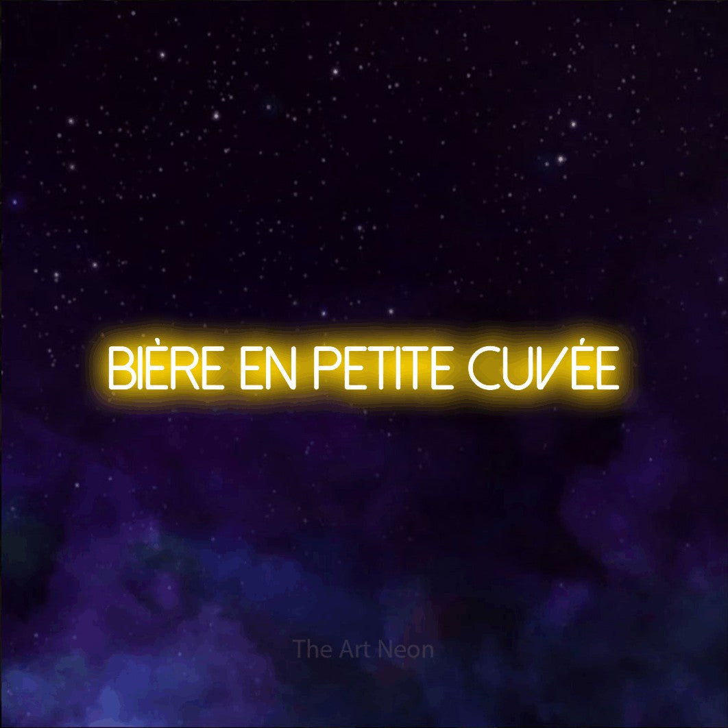 “Bière en petite cuvée” LED neon sign in yellow, with thin sans-serif lettering, shown against a purple galaxy backdrop.