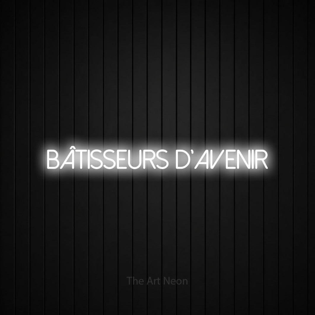“Bâtisseurs d'avenir” LED neon sign in cool white, with thin sans-serif lettering, shown against black vertical wall slats.
