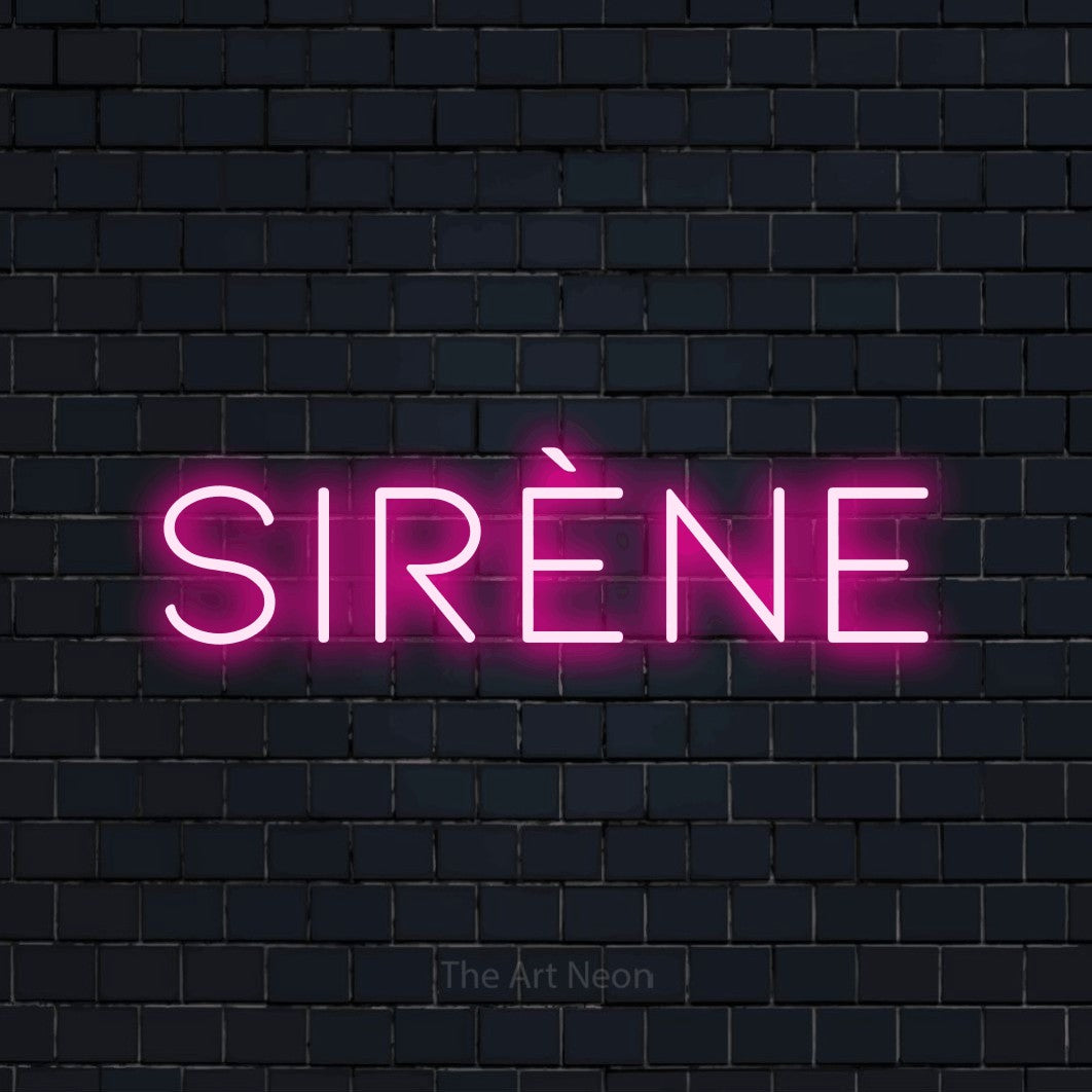 “Sirène” LED neon sign in hot pink, with thin, widely spaced lettering, shown against a dark navy brick wall.