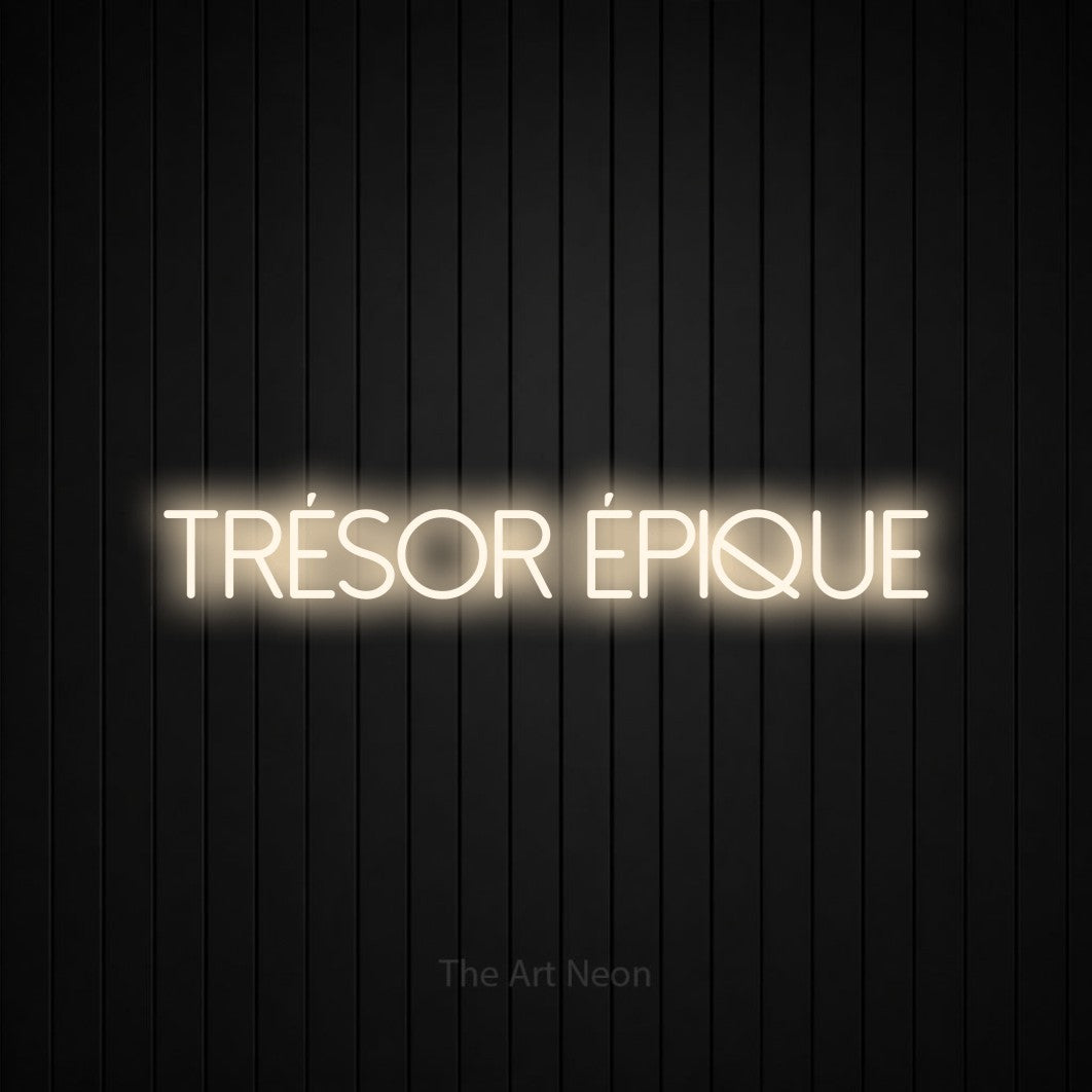 “Trésor épique” LED neon sign in warm white, with thin sans-serif lettering, shown against black vertical wall slats.