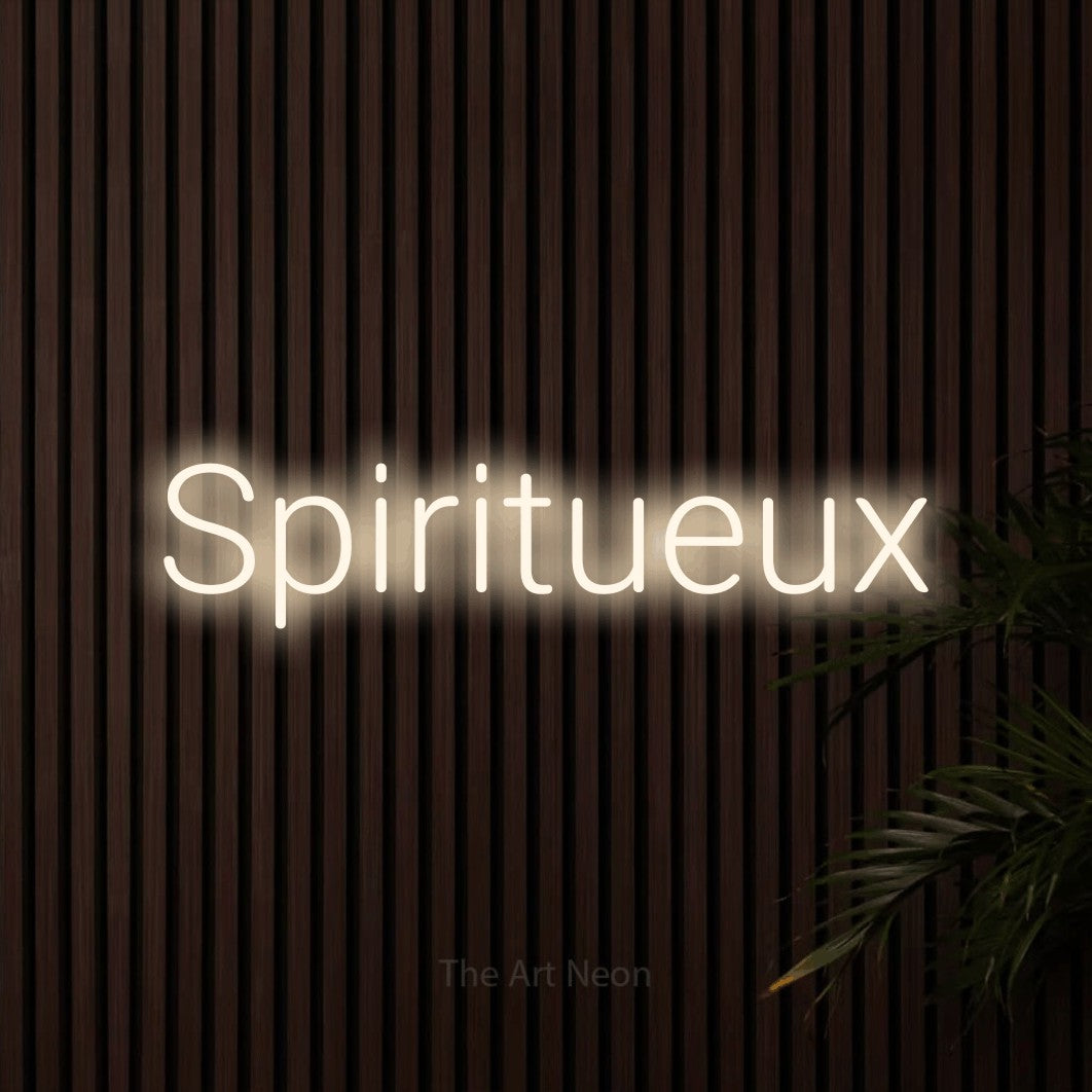 “Spiritueux” LED neon sign in warm white, with rounded sans-serif lettering, shown against dark wooden wall slats.
